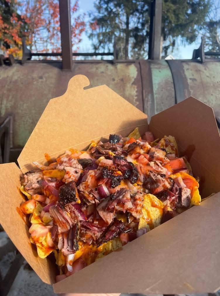 BBQ nachos loaded with pulled meat, onions, and sauce