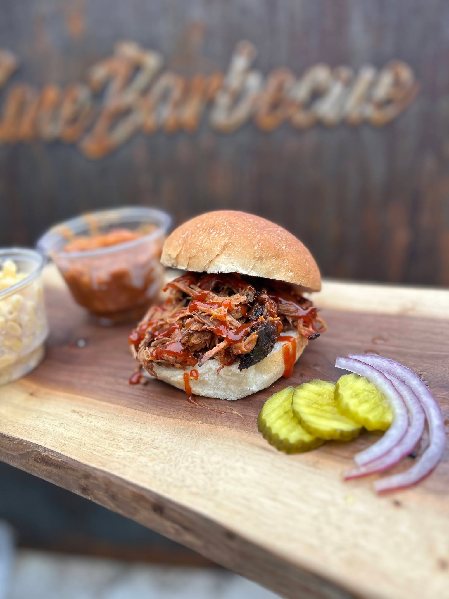 Pulled pork sandwich on a wooden board